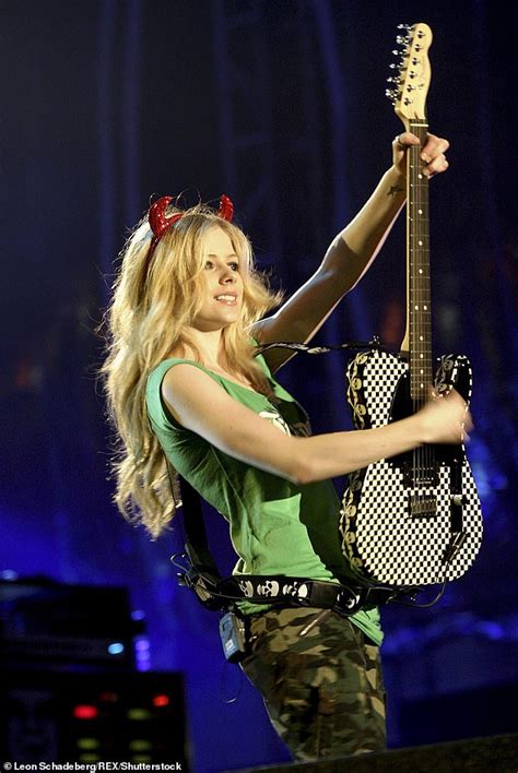 Avril Lavigne appears NUDE behind a guitar on cover for new album